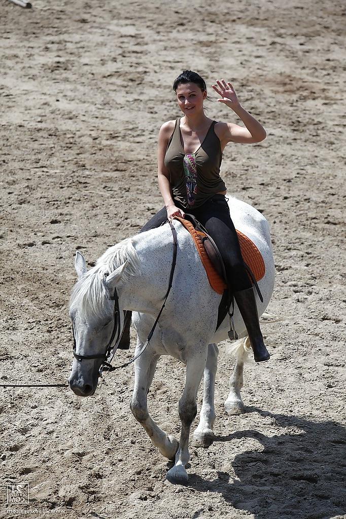 16P Pornstar Aletta Ocean is riding a horse outdoor in glasses