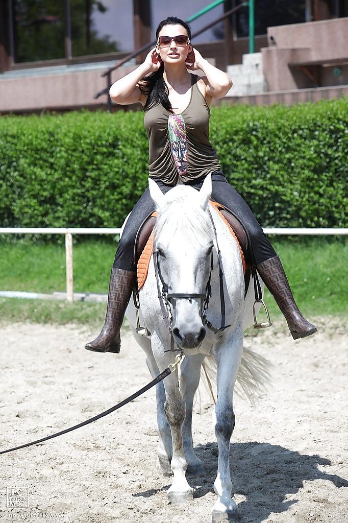 16P Pornstar Aletta Ocean is riding a horse outdoor in glasses