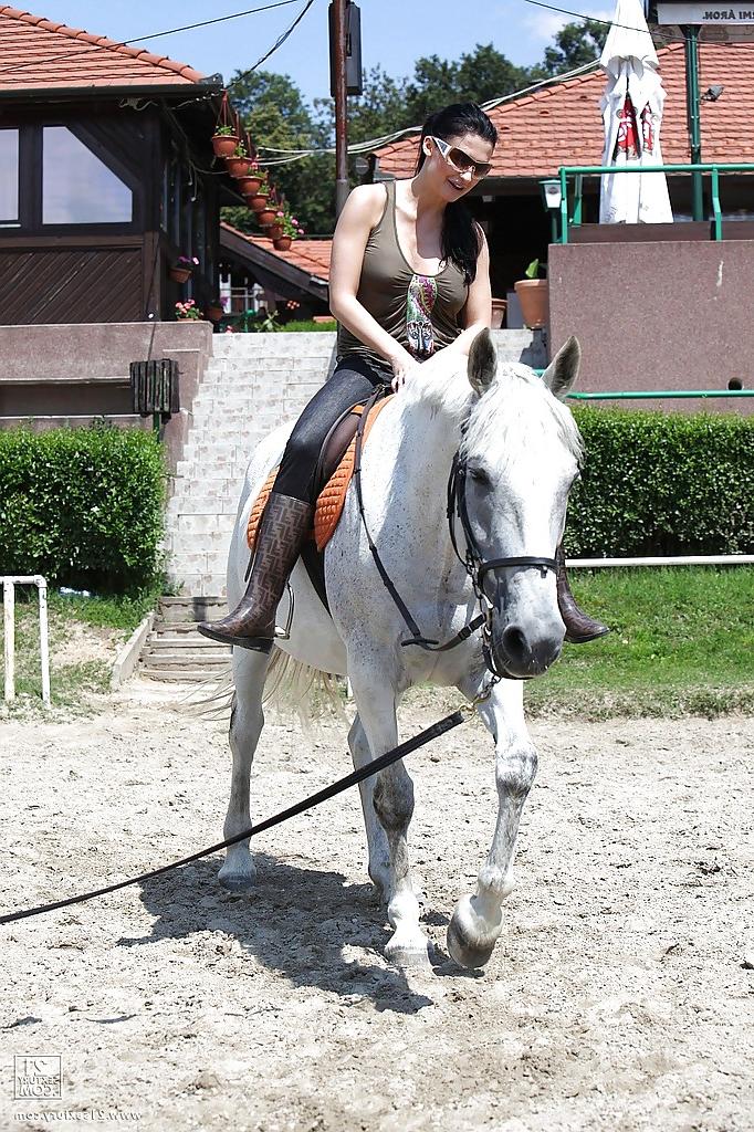 16P Pornstar Aletta Ocean is riding a horse outdoor in glasses