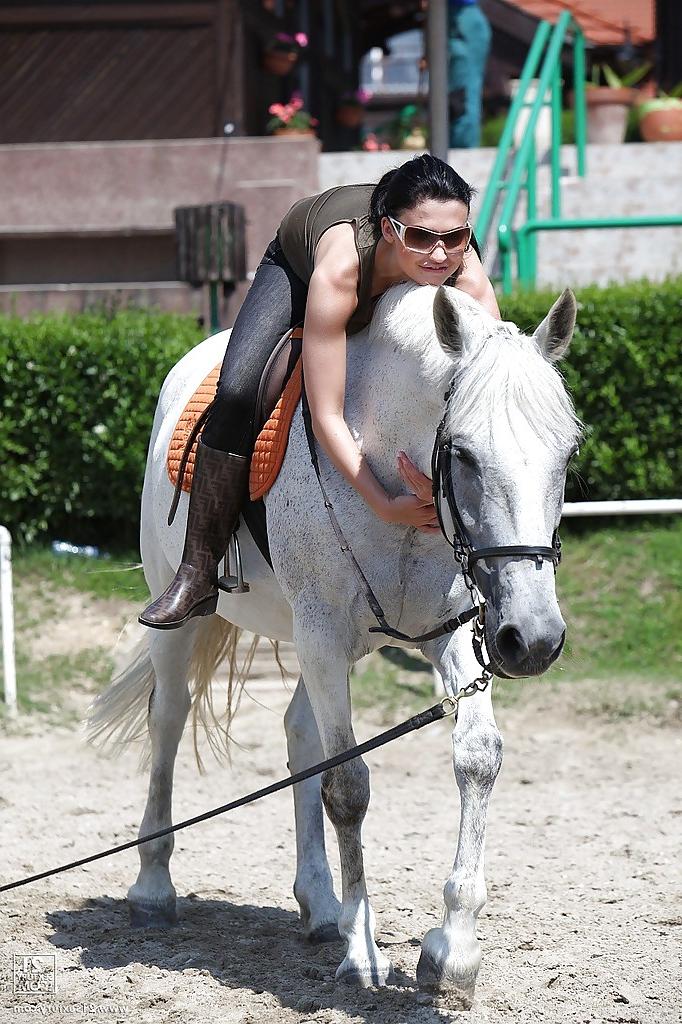 16P Pornstar Aletta Ocean is riding a horse outdoor in glasses
