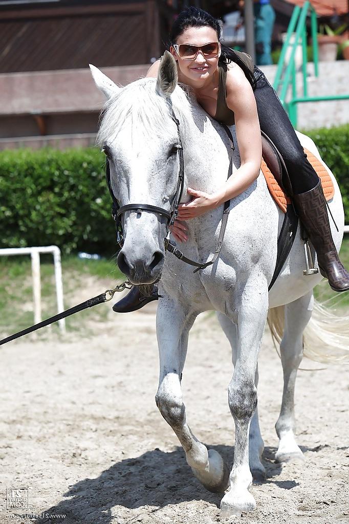 16P Pornstar Aletta Ocean is riding a horse outdoor in glasses