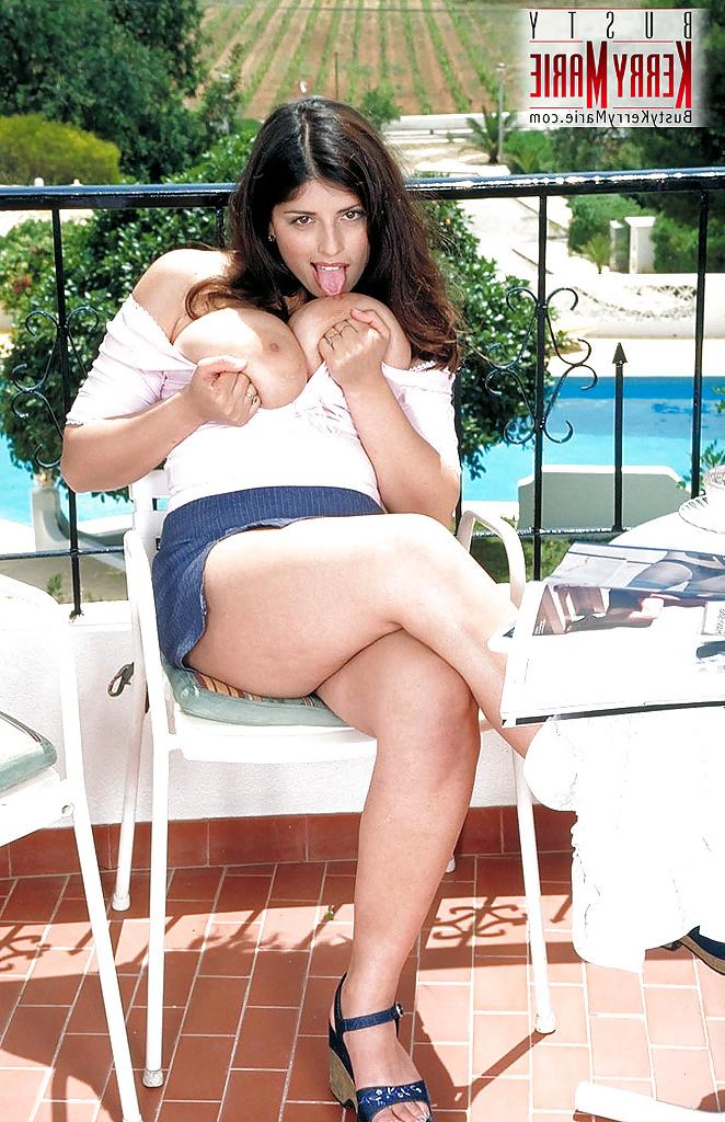 16P Chesty MILF pornstar Kerry Marie unveiling huge tits outdoors in skirt