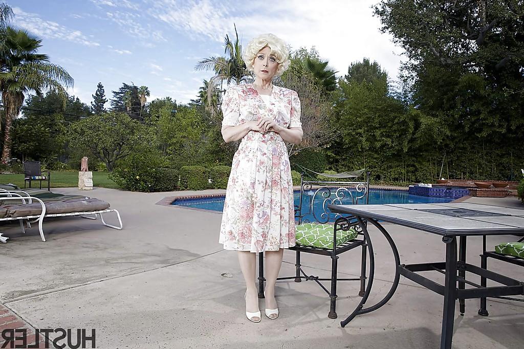 16P Mature pornstar Nina Hartley modelling outdoors in garters and nylons