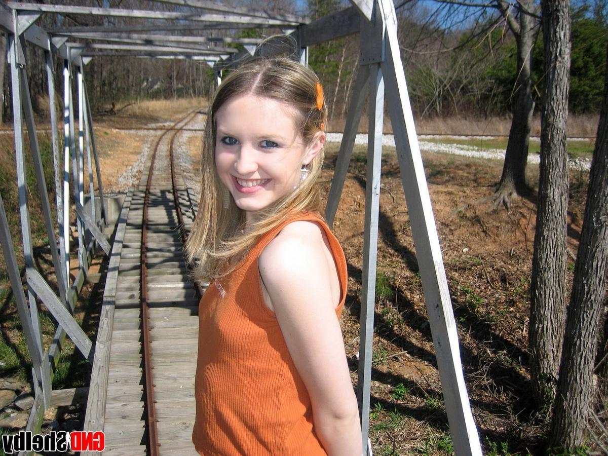 12P Cute petite teen Shelby flashes her perky tits outdoors at the public park