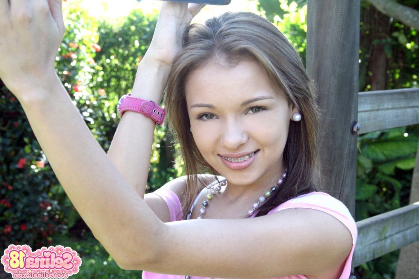16P Cute teen with braces revealing her perky tits outdoors