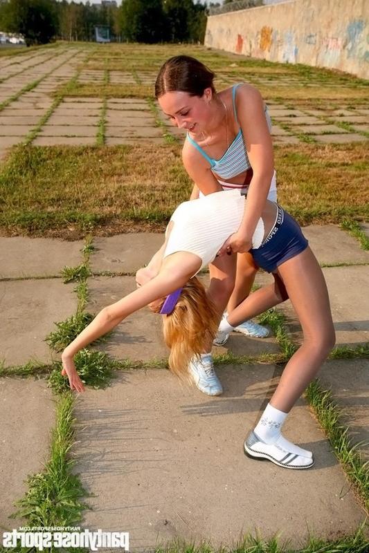 12P Two sporty babes exercise in tights outdoors