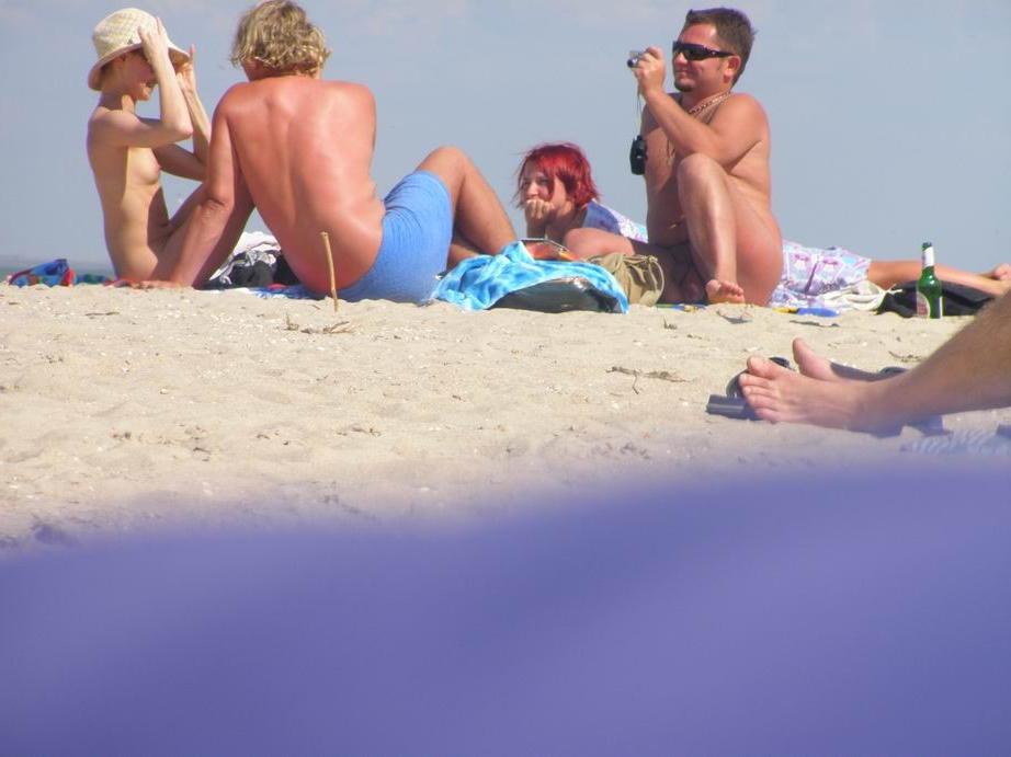 15P Sexy milf bares all at a nudist beach in the sun