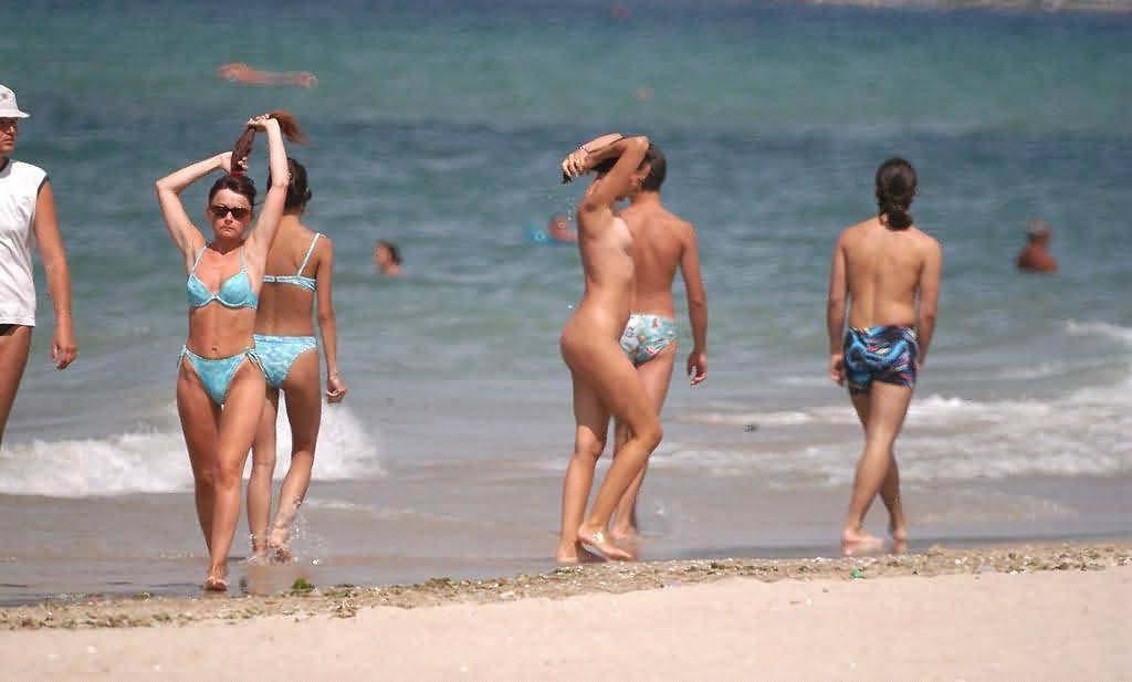 15P Dark haired nudist beach teen gets an all over tan