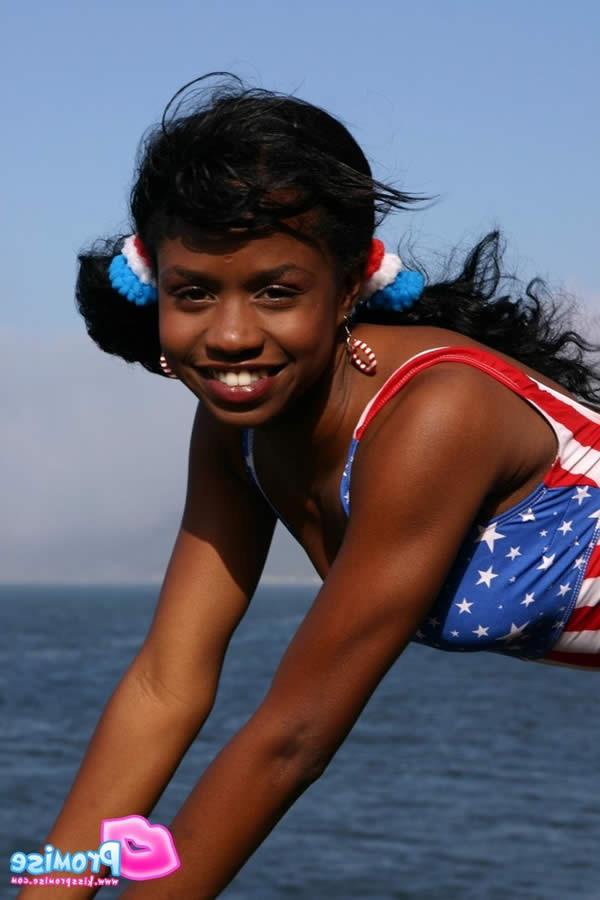 15P Ebony teen in bathing suit strips by the ocean