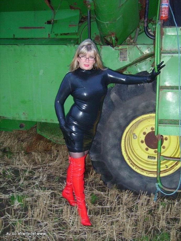 12P Fetish wife wearing latex and high red boots outdoors