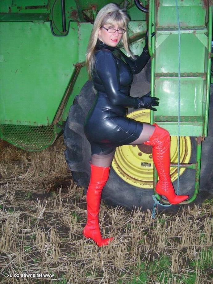 12P Fetish wife wearing latex and high red boots outdoors