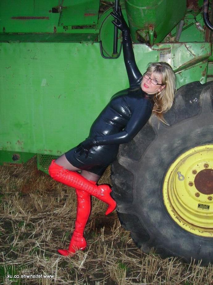 12P Fetish wife wearing latex and high red boots outdoors