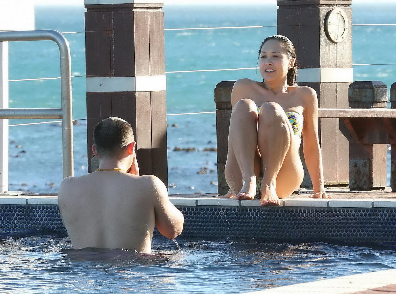 16P Myleene Klass wearing tube flower print bikini at the pool in South Africa