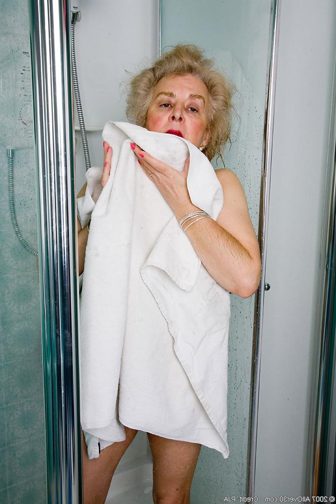 15P Check out this busty granny spreading her aged old vagina wide open
