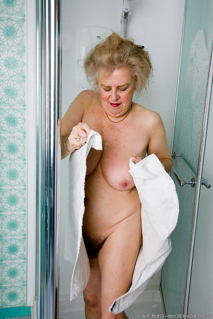 15P Check out this busty granny spreading her aged old vagina wide open