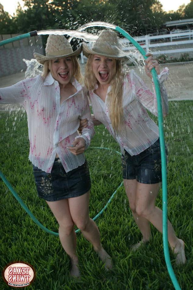 15P Twin eighteen year old sisters hosing each other off outdoors