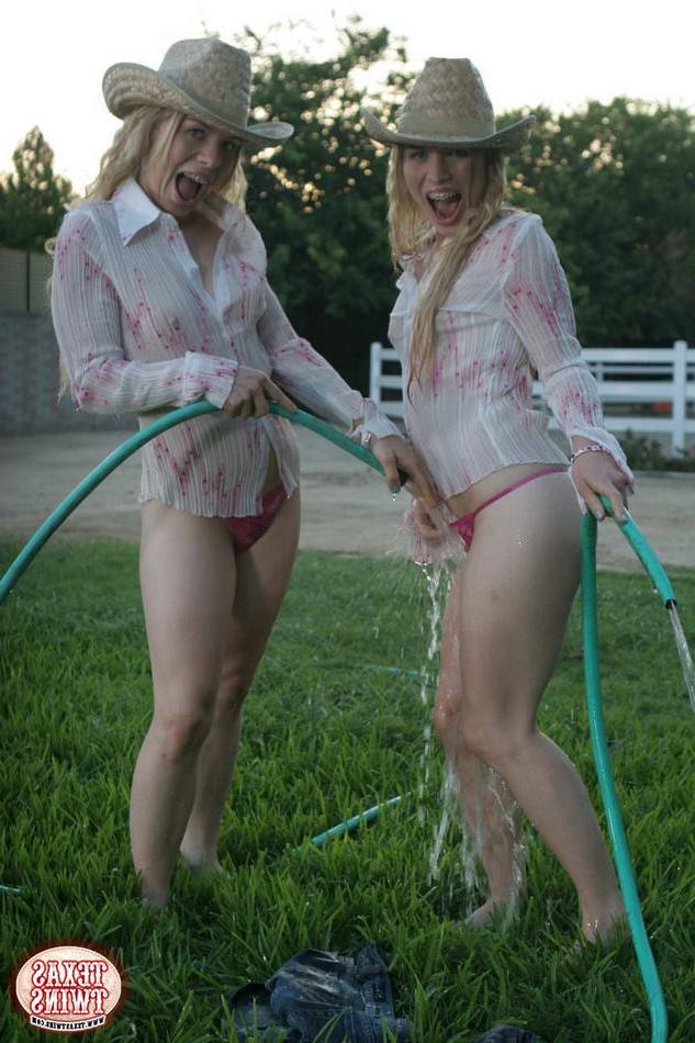 15P Twin eighteen year old sisters hosing each other off outdoors