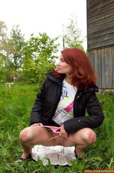 15P Sweet redhead beauty peeing on newspaper outdoors