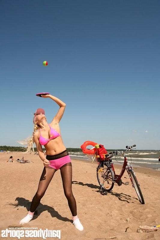 12P Blonde Victoria doing pantyhose aerobics at seashore