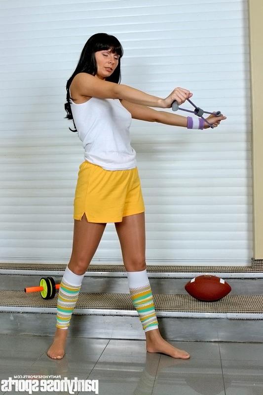 12P Brunette Kristy in pantyhose working out with stretching expander