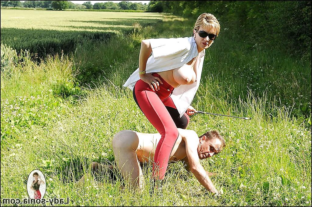 15P Lusty mature lady in sunglasses tortures her manslave outdoor