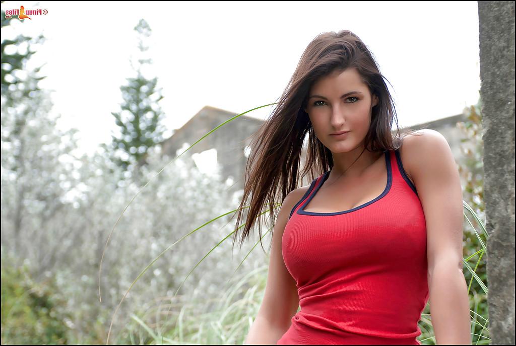 16P Brunette Euro babe Emma Twigg freeing large natural tits and ass outdoors