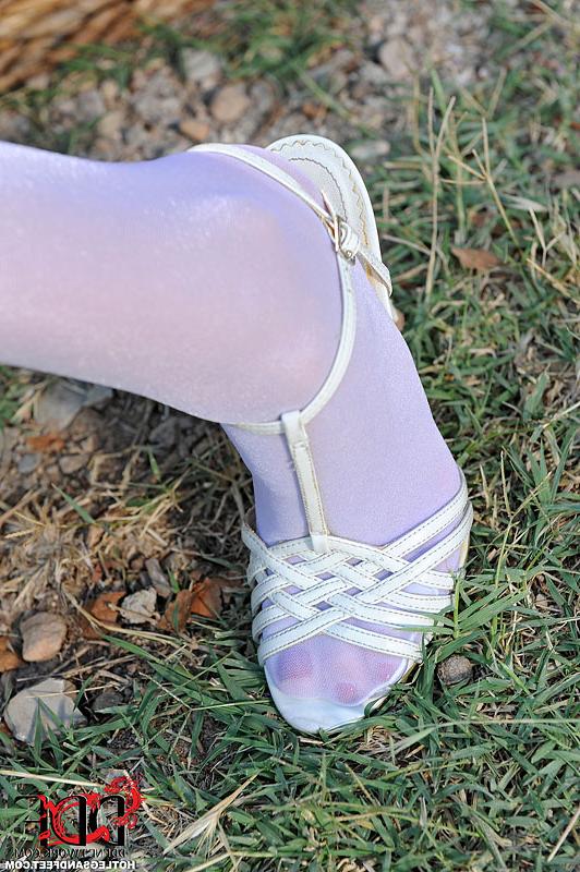 16P Redhead Denisa Heaven removes stockings from legs and feet outdoors