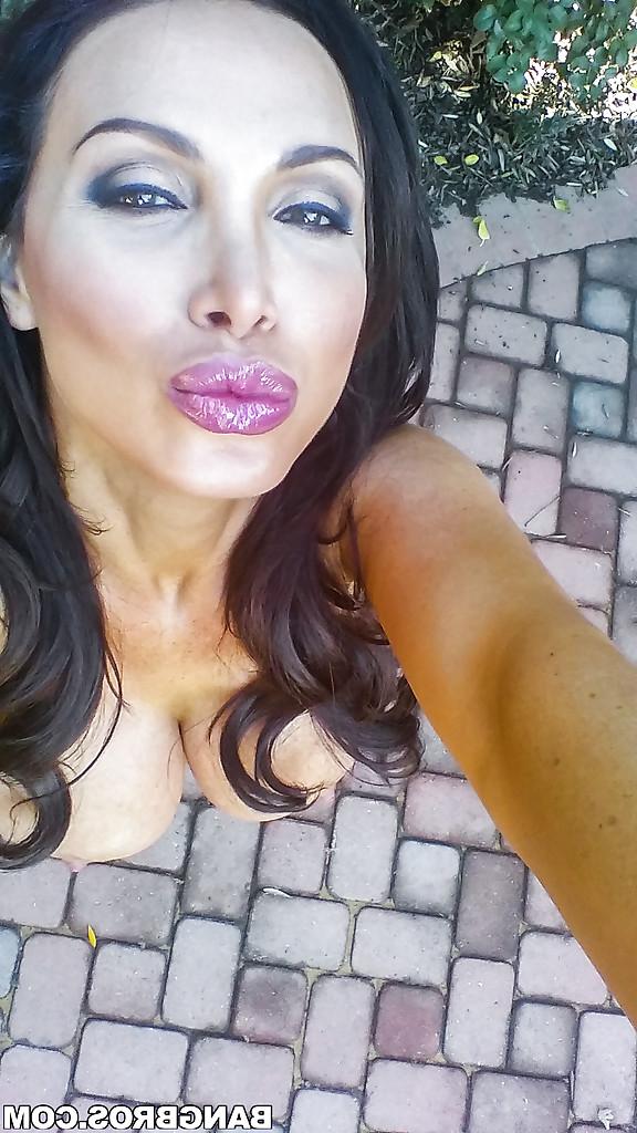 16P Buxom MILF Nikki Benz posing topless outdoors in denim shorts