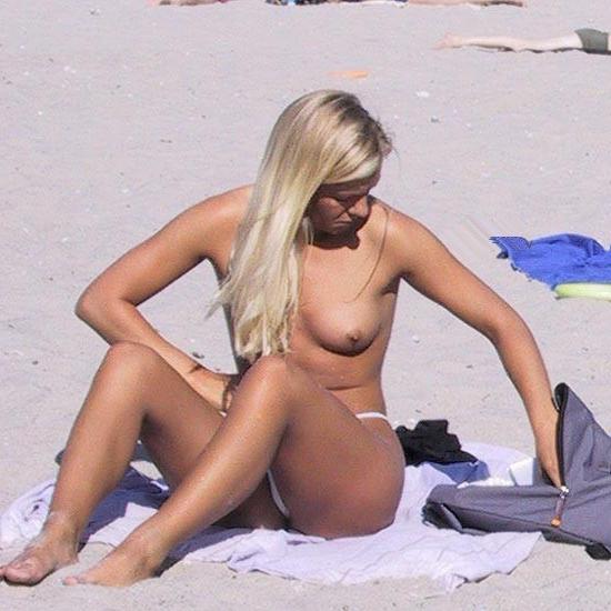 15P All eyes are on this young nudist as she sunbathes