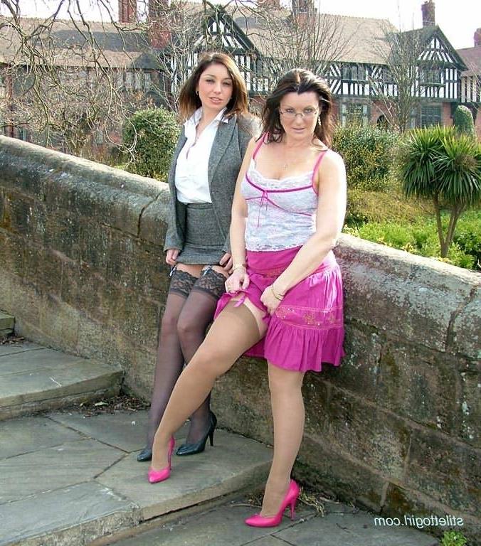 15P Two stocking models in stiletto heels posing outdoors