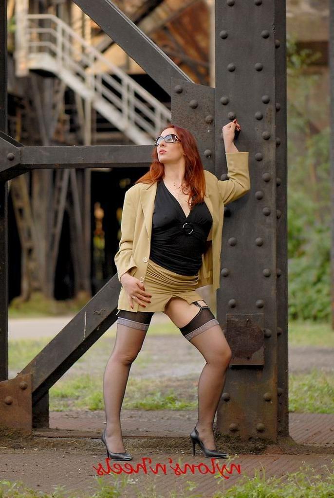 12P Redhead lady Justine in stockings spreading outdoors