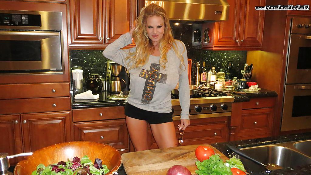 16P Clothed amateur mature Kelly Madison is showing her big tits in kitchen