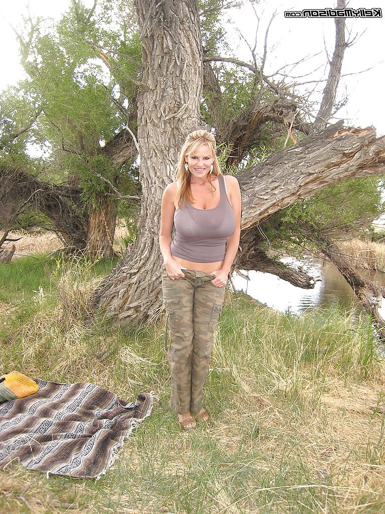 16P Outdoor posing scene of an amateur milf babe in a lingerie Kelly Madison