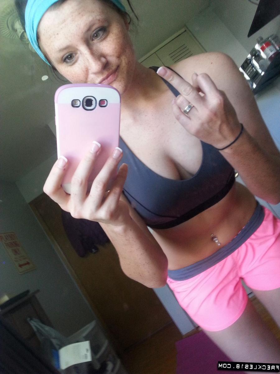 12P Pierced amateur Freckles takes self shot posing in shorts & sexy panties