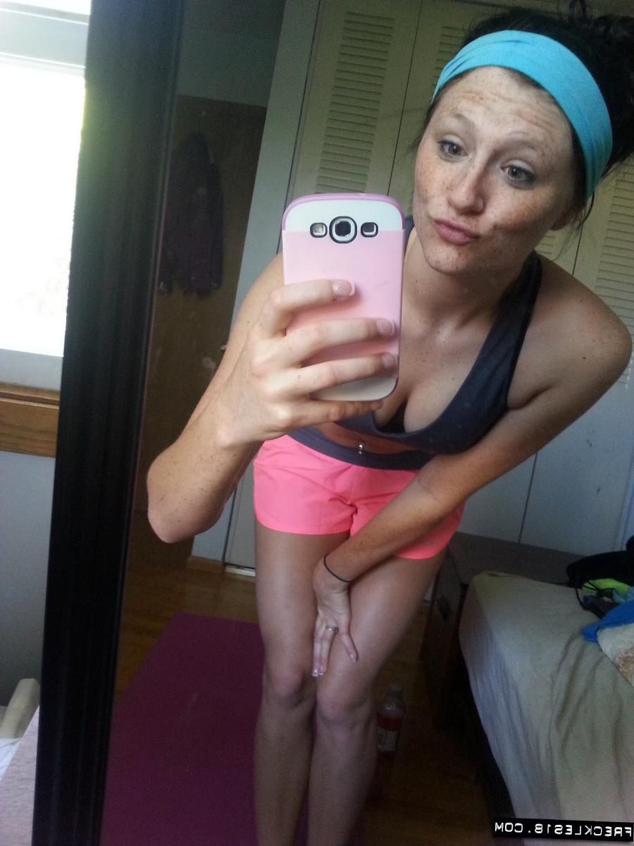 12P Pierced amateur Freckles takes self shot posing in shorts & sexy panties