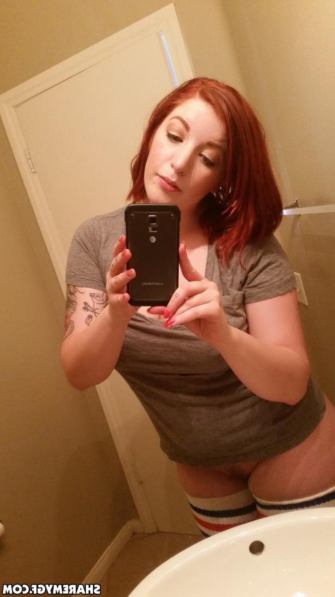 12P Busty redhead GF shows off her big natural tits as she takes selfies in the mirror