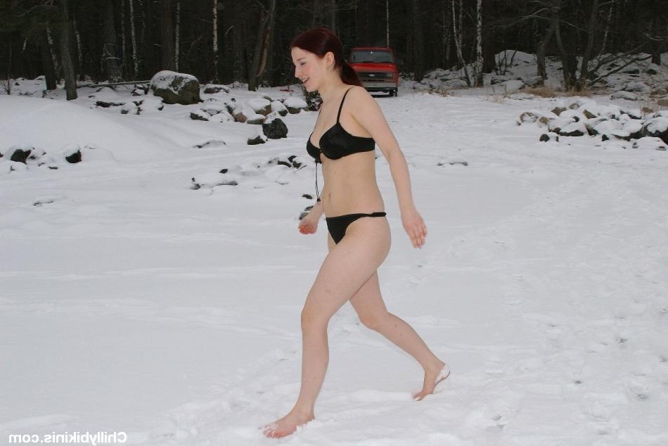 20P Sexy redhead bikini babe making snow angels