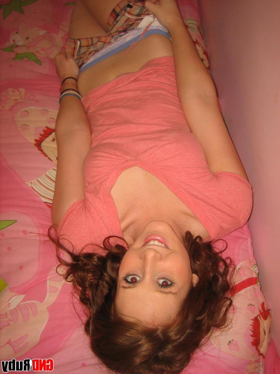 12P Redhead teen Ruby strips out of her pink shirt and undies exposing her perky tits and tight pussy