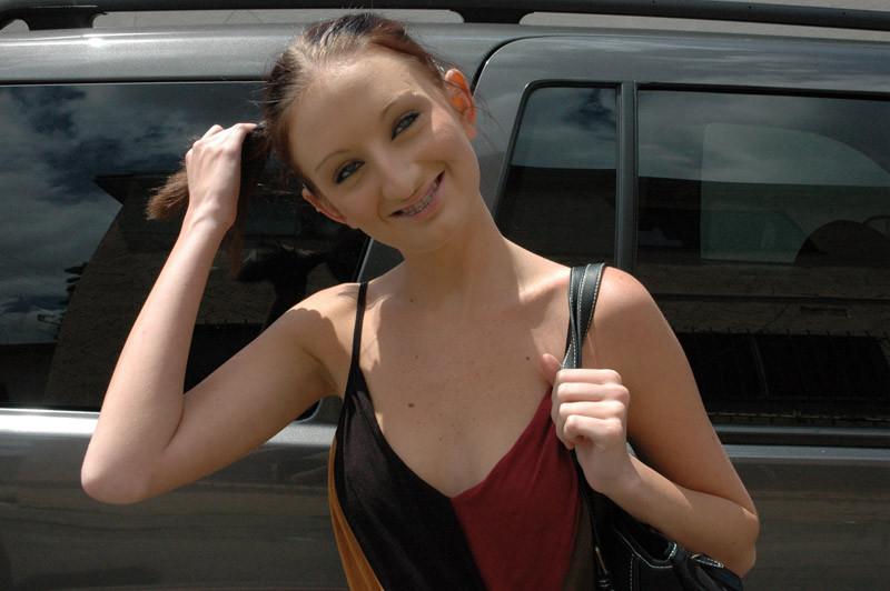 20P Teen fans herself with cash.