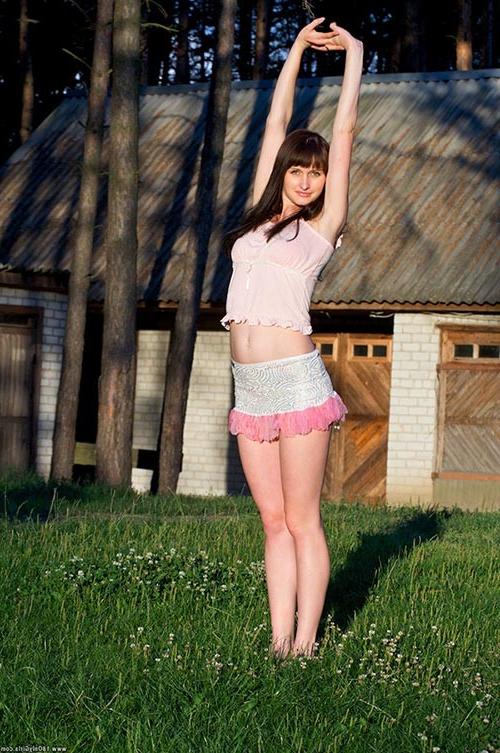 16P Young charming amateur brunette showing her naked body outdoors