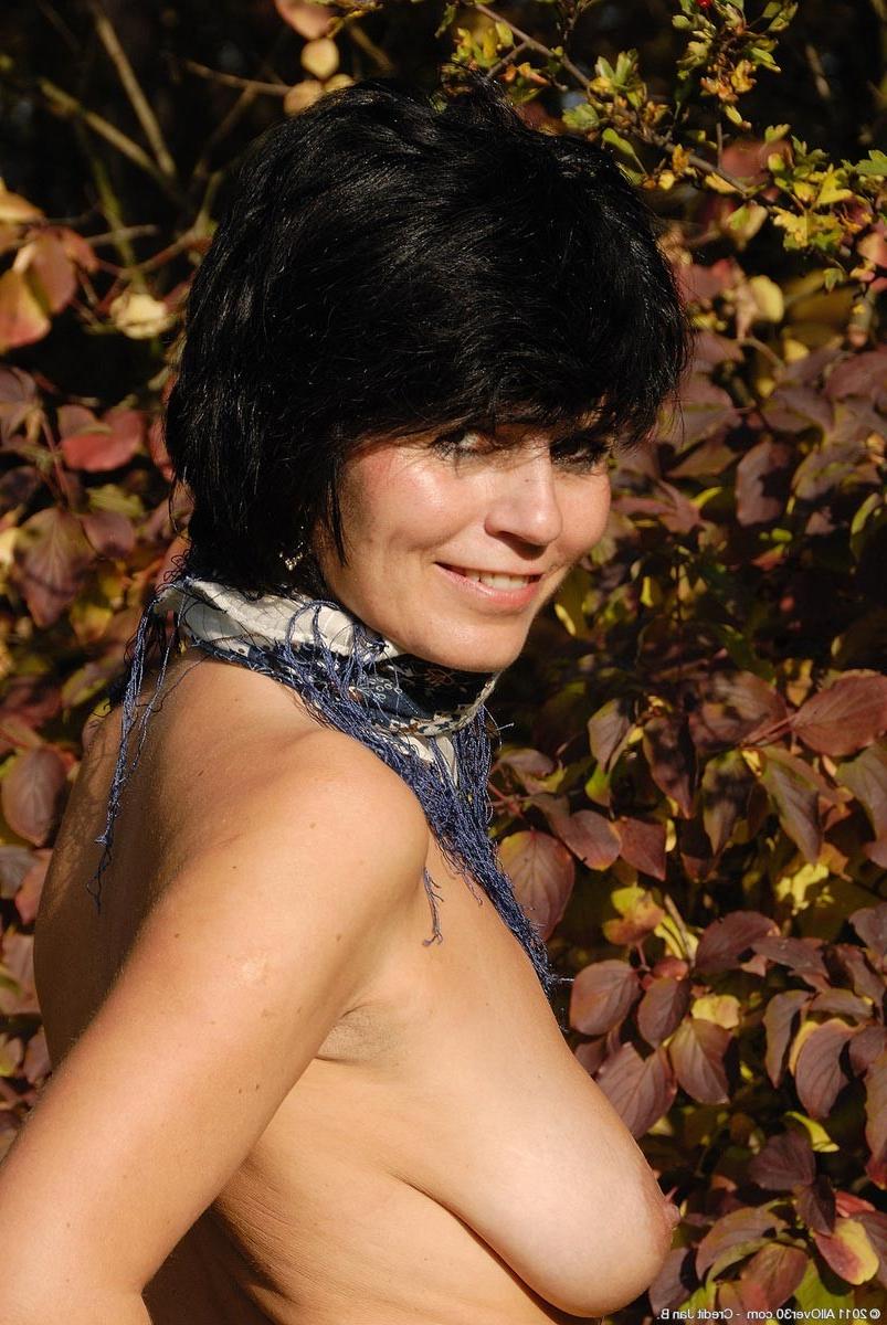15P Horny slim mature with big tits in the backyard