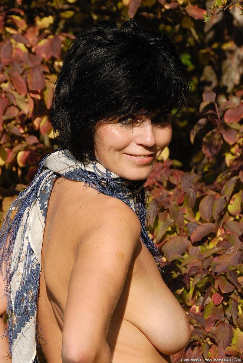 15P Horny slim mature with big tits in the backyard