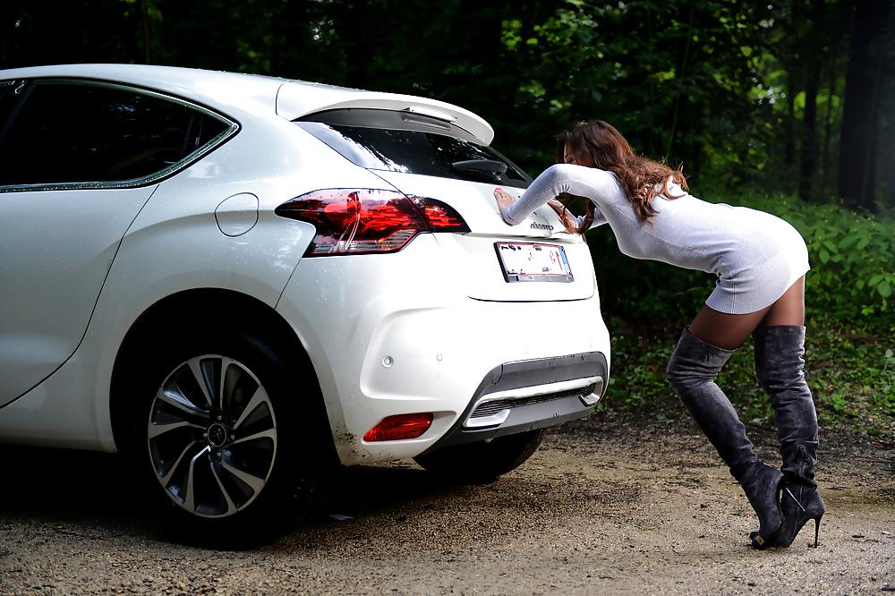 6P Bootfetish: girl in thigh high boots pushing a car 