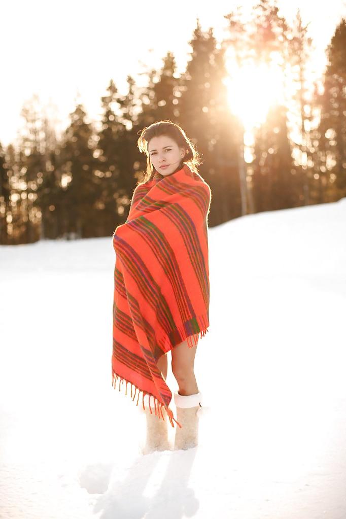16P Cute brunette wearing only boots in the snow
