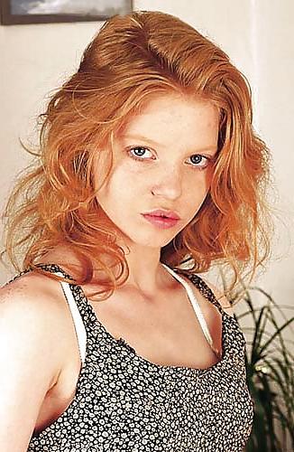 20P Saucy redhead undressing and masturbating