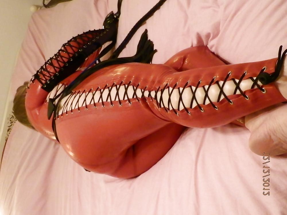 25P Mistress in her red latex catsuit