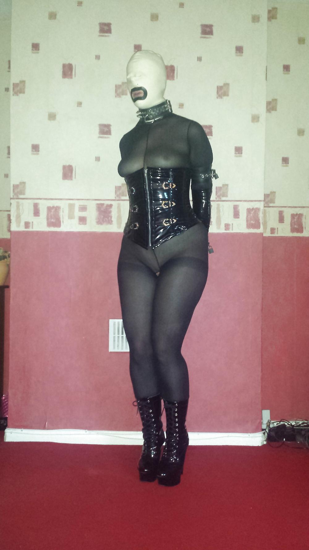 8P Slave girl in white rubber hood and ankle boots