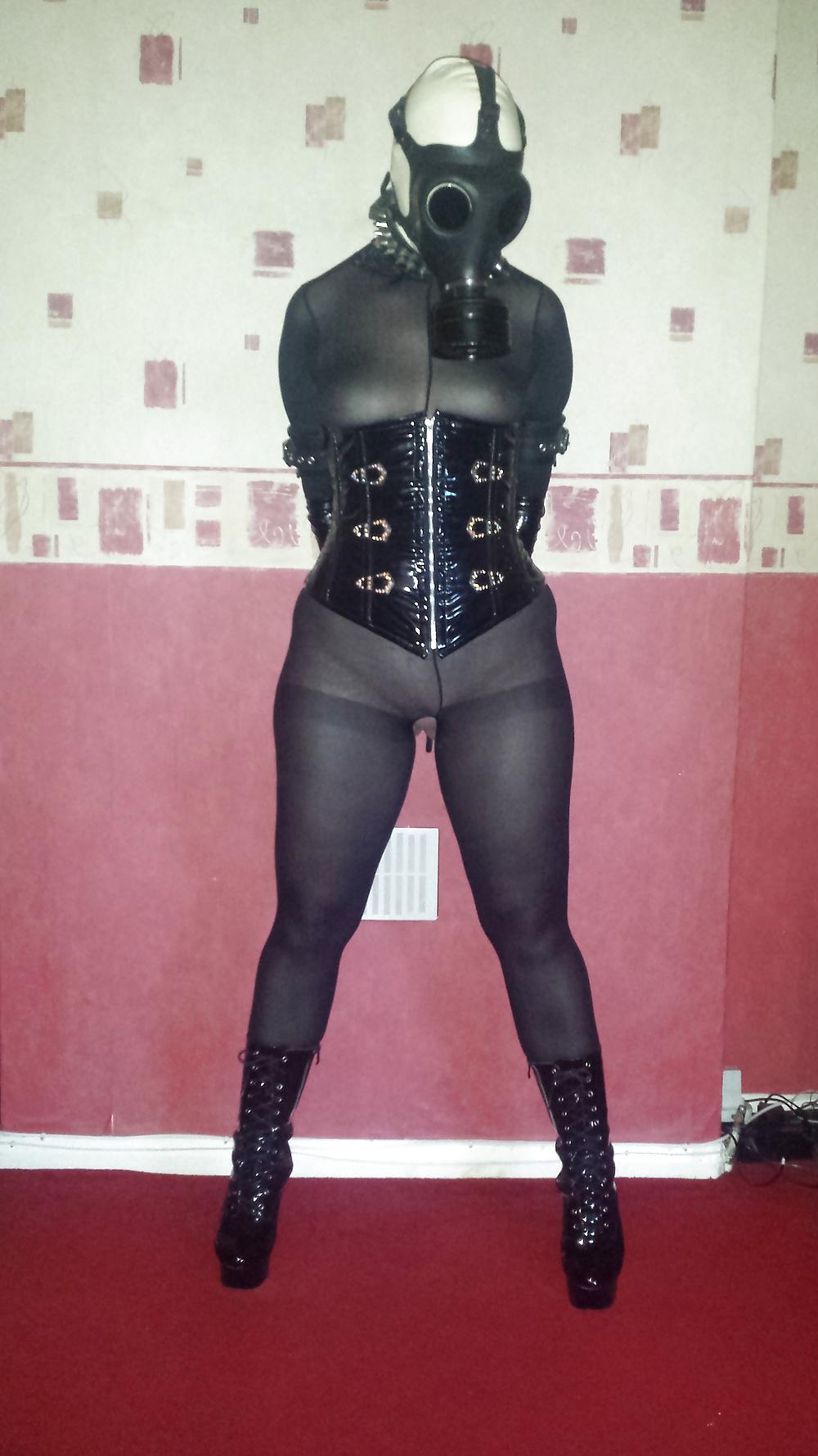 9P Rubber gas mask wearing slave girl in ankle boots
