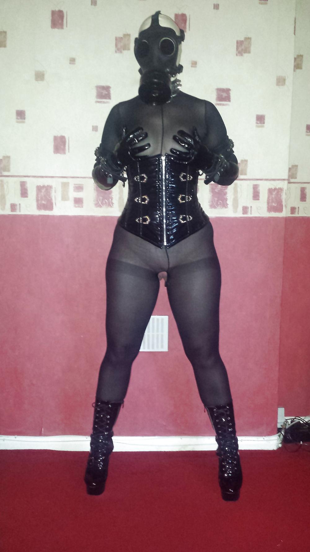 9P Rubber gas mask wearing slave girl in ankle boots