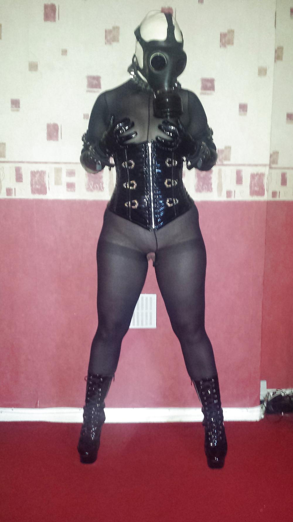 9P Rubber gas mask wearing slave girl in ankle boots